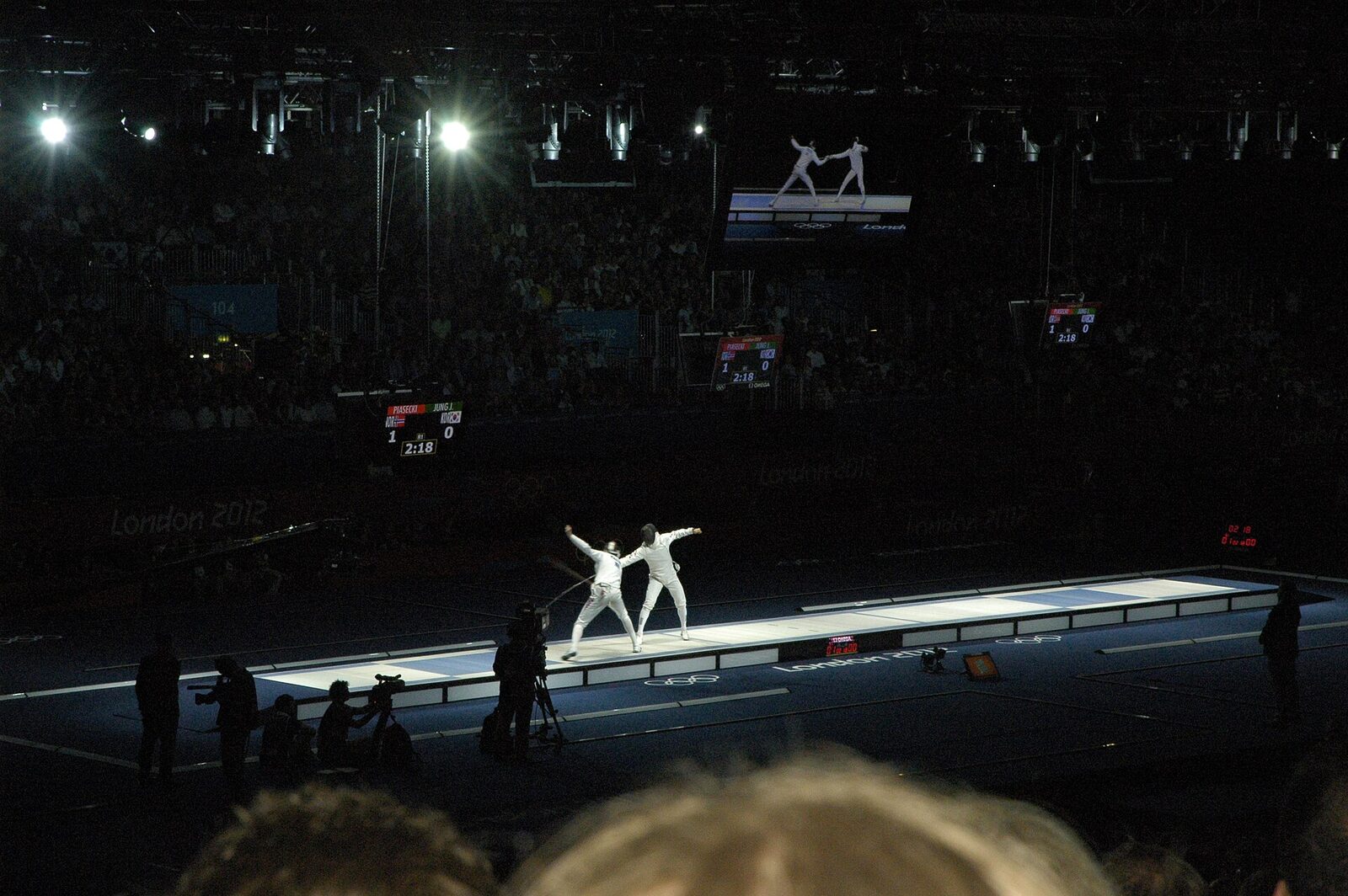 The men's epee semi-final at the London 2012 Olympics, fenced on a glowing strip at the center of a darkened arena