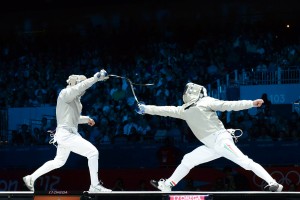 Ochiuzzi (ITA, left) in action at the 2012 Olympics - Men's Sabre.  Photo C. Harkins / Fencing.Net